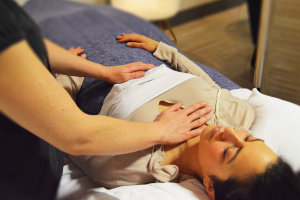 NHPC therapist performs Therapeutic Touch on a prone client. 