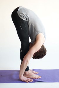A yoga practitioner in a standing forward fold.