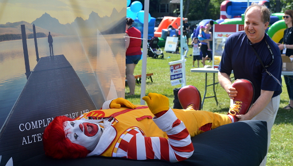 NHPC member Karl Faes giving Ronald McDonald a massage at the Ronald McDonald House Charities Northern Alberta Block Party