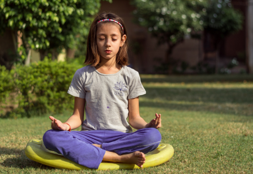 A child in the yoga lotus pose