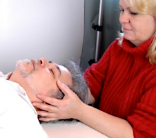 A craniosacral practitioner working on a client