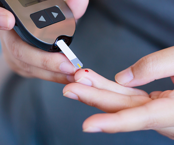 Diabetic pricking their finger to check blood sugar