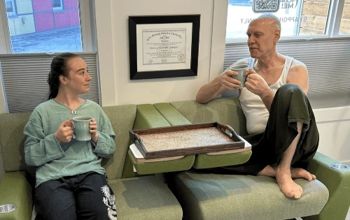 NHPC Thai massage practitioner Grant Martens sharing tea with a client.