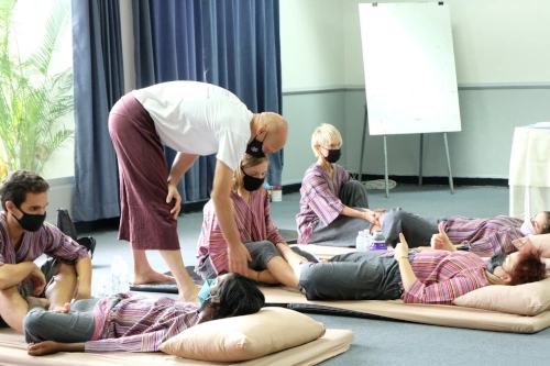 NHPC Thai massage practitioner Grant Martens instructing a student on positioning. 
