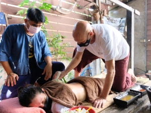 NHPC Thai massage practitioners Grant Martens instructing a student on a prone client.