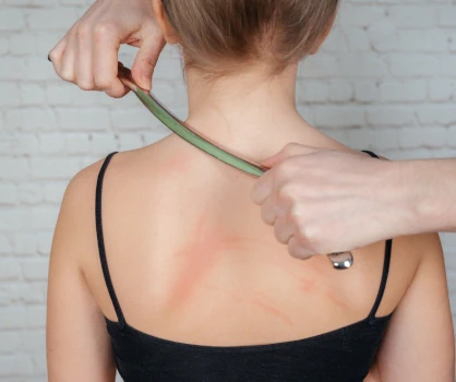 Instrument-assisted soft-tissue mobilization performed on upright client