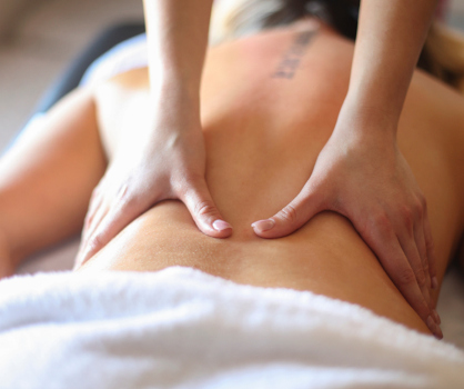 A client receiving massage on their lower back. 