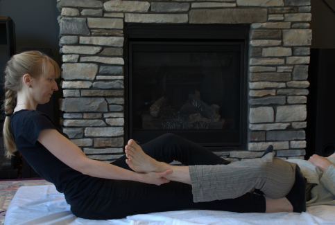 Michele Somer performing mobile massage in a seated position.