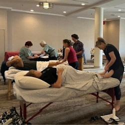 Practitioners with massage tables at an NHPC conference workshop