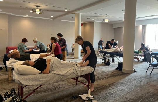 Practitioners with massage tables at an NHPC conference workshop