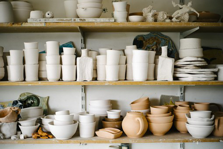 Shelves filled with pottery waiting to be decorated. 