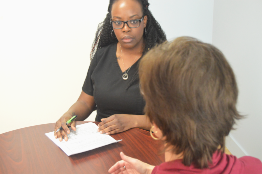 Practitioner discusses records with client.