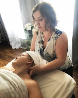 A practitioner working on the neck of a client