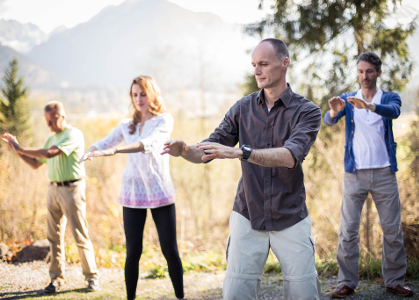 Qigong practitioners outdoors on a sunny day