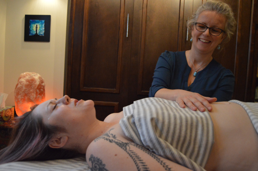 NHPC practitioner performing visceral manipulation on a client